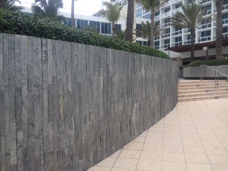 Carillon Hotel — curved slate-clad wall along the entry walkway